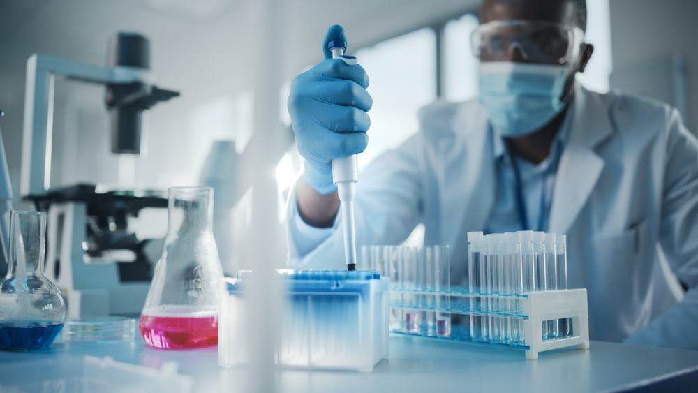 male scientist using pipette in a laboratory